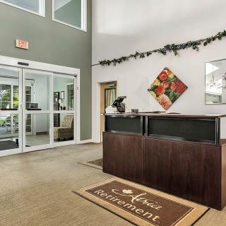 A welcoming reception area with a desk, decor, and entrance doors.