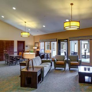 A spacious and modern living room with comfortable seating and stylish lighting.