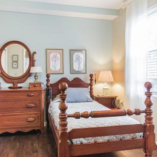 A traditional bedroom with wooden furniture and soft lighting.