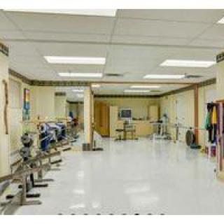 An indoor gym with exercise equipment and workout space.