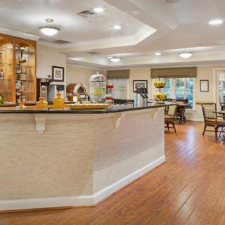 A cozy cafe interior with a central counter and seating area.