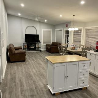 Open concept living area with a kitchen island, dining table, and cozy seating.