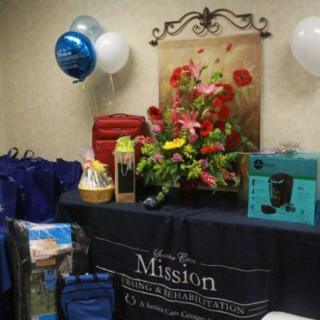 A festive display with balloons, gifts, and floral arrangements set up for a special event.