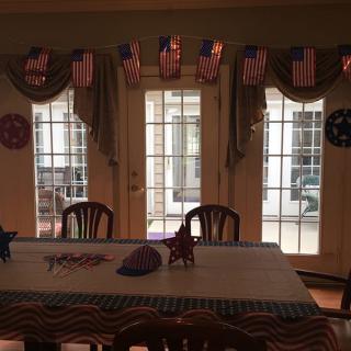 A dining room decorated with American flags and patriotic themes.
