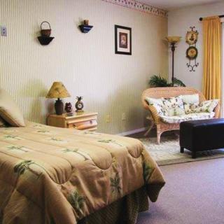 A cozy bedroom with a bed, sofa, and decorative elements.