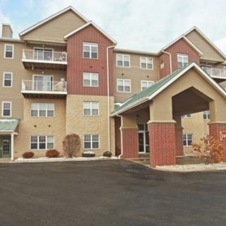 A multi-story residential apartment building with a covered entrance.
