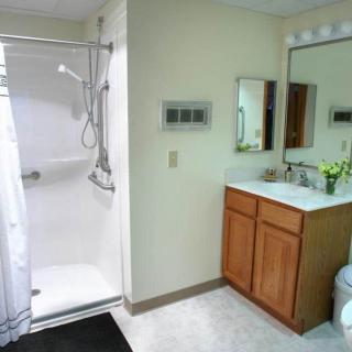 A modern bathroom featuring a shower and a vanity with mirrors.