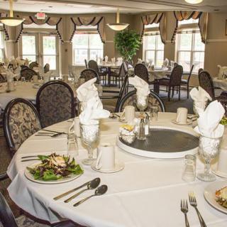 An elegantly set dining room prepared for a banquet.