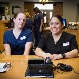 Healthcare professionals posing for a photo in their workspace.