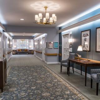 A well-lit hallway with elegant decor and comfortable seating.