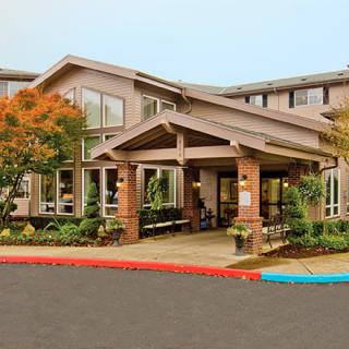 A modern building entrance with landscaped surroundings.