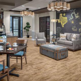A cozy living room with comfortable seating, a chalkboard wall, and stylish lighting.