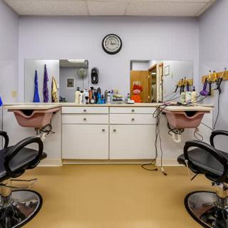 An interior view of a hair salon with two styling stations and mirrors.