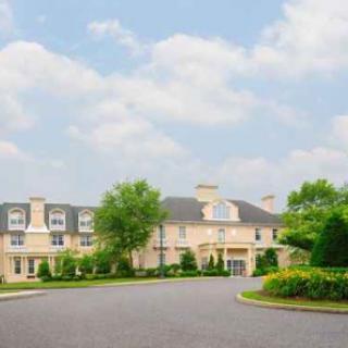 A beautiful residential mansion set against a serene sky.