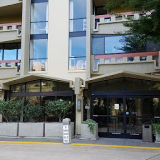A modern commercial building with large glass windows and a welcoming entrance.