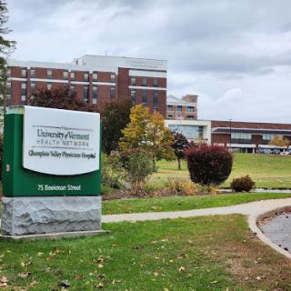 A view of the University Hospital along with its signage, showcasing a healthcare facility in a scenic outdoor setting.
