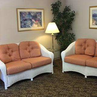 An inviting waiting room with two cozy sofas and warm lighting.