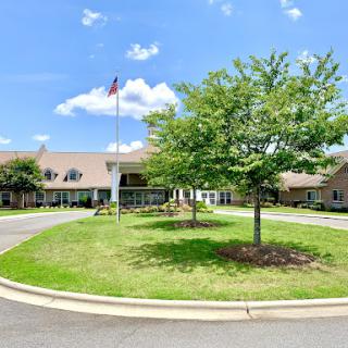 A welcoming view of a community building surrounded by green landscaping.