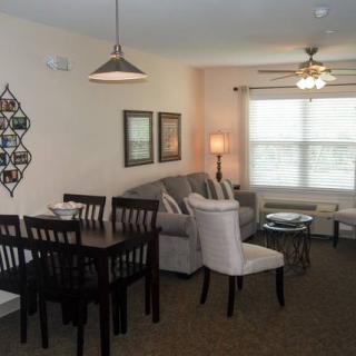 A cozy apartment living room with a dining area, featuring comfortable furniture and stylish decor.