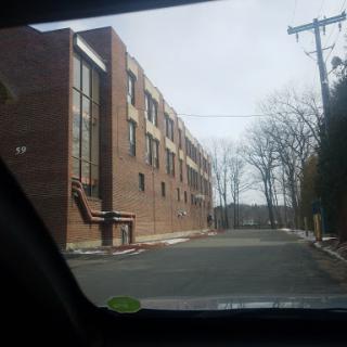 A view of a brick building along a quiet street.