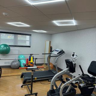 A well-equipped gym space featuring various exercise machines and fitness tools.