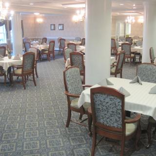 An elegantly decorated dining room with neatly arranged tables and chairs.