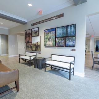 A modern lobby with comfortable seating and decorative artwork on the walls.