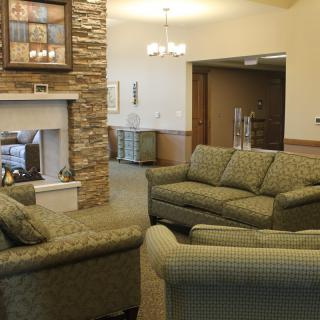 A cozy living room with comfortable sofas and a fireplace.