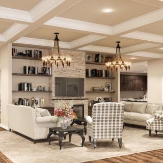A cozy and modern living room featuring a fireplace, comfortable sofas, elegant chandeliers, and built-in bookshelves.
