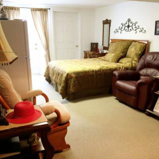 A cozy bedroom with a comfortable bed and seating area.