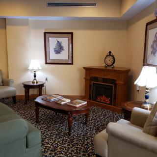 A cozy living room with elegant furniture and a warm fireplace.