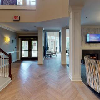 A modern lobby area with herringbone flooring and elegant decor.
