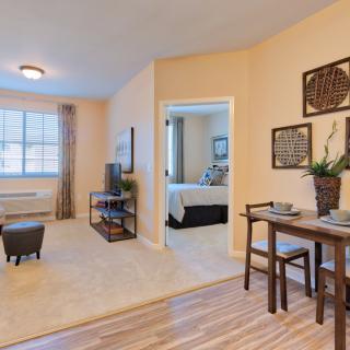 A cozy apartment interior featuring a living room and dining area with modern decor.