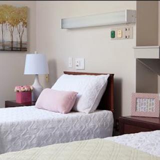 A tidy hospital room with neatly arranged beds and calming decor.
