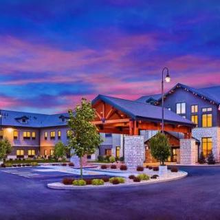 A modern hotel building at sunset with a welcoming entrance.