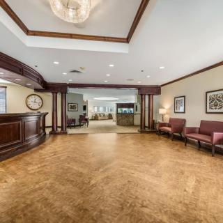 A spacious lobby with elegant wood flooring and a welcoming reception area.