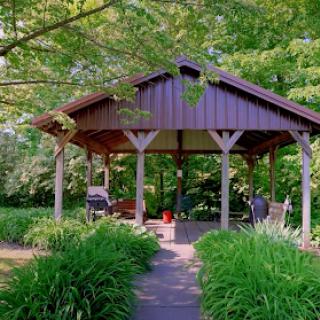 A serene gazebo surrounded by lush greenery, perfect for a peaceful retreat.