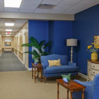 A cozy lobby with blue walls and comfortable seating.