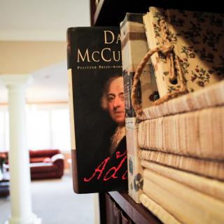 A bookshelf with a prominently displayed biography on it.