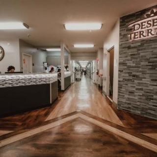 A modern hospital reception area with a sleek design and warm lighting.