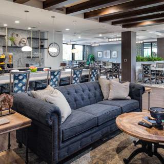 A modern lounge area with a stylish couch and coffee table in an open space setting.
