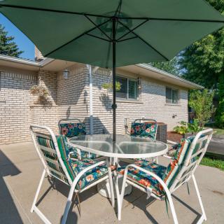 A cozy patio setup with a table, chairs, and an umbrella.