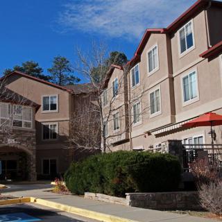 A view of a hotel building under a clear blue sky.