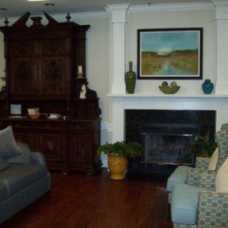 Cozy living room with a fireplace, comfortable seating, and elegant decor.