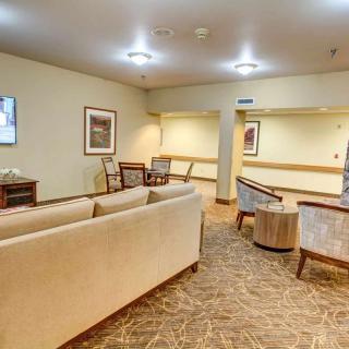 A cozy living room with comfortable seating arrangements and warm lighting.