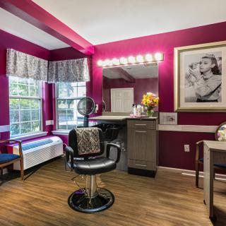 A cozy hair salon with stylish decor and bright lighting.