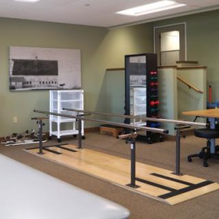 A spacious office environment featuring desks, a vending machine, and training equipment.