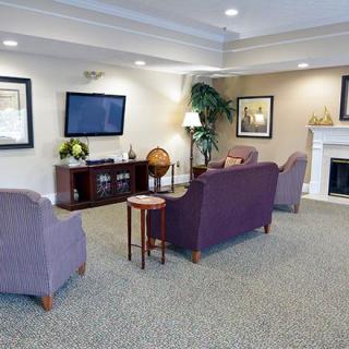 A cozy living room with elegant furniture and a television.