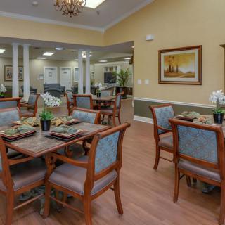 A well-decorated dining area with neatly arranged tables and chairs.