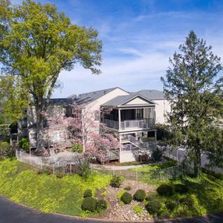 A beautiful residential home surrounded by lush greenery and a well-maintained garden.